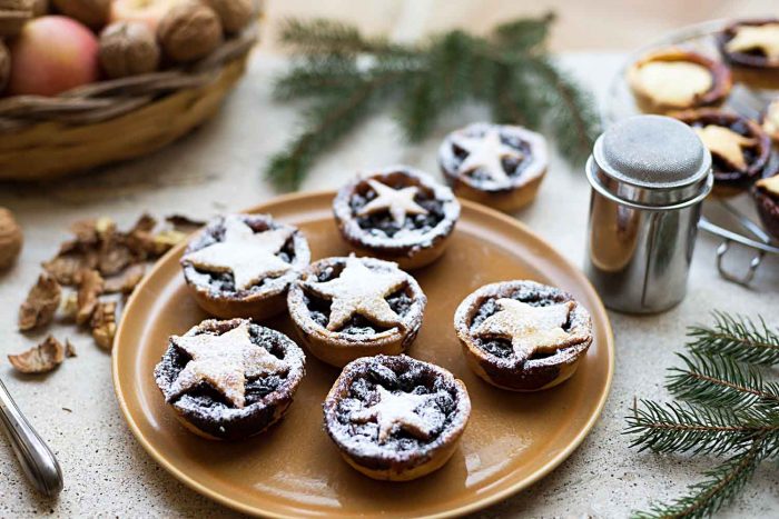 Traditional Christmas Mince Pies with shortcrust pastry filled with mincemeat (apples, butter, brandy, spices, citrus and dried fruits)